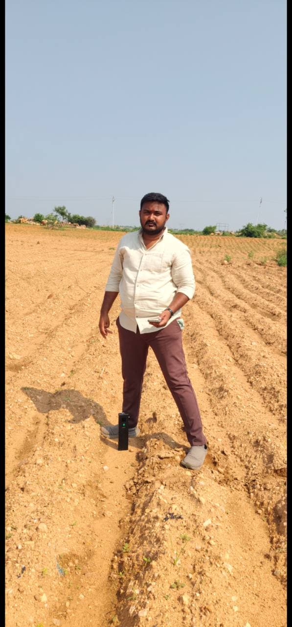 Field operator standing beside Soilo Essence in prepared crop rows