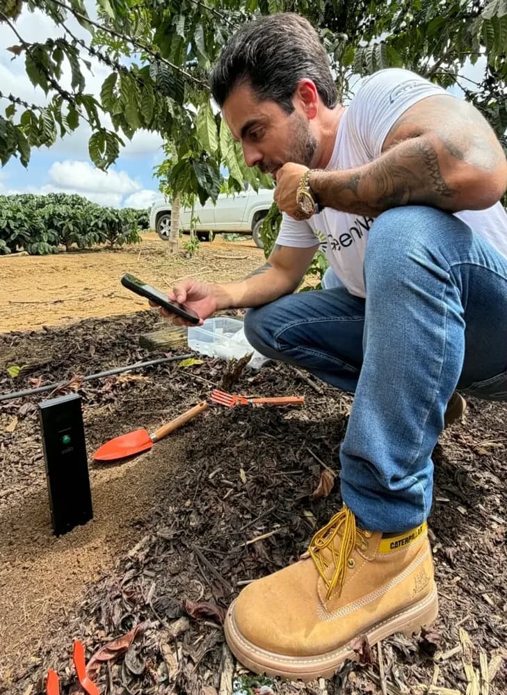Coffee farmer checking Soilo Essence results on his phone