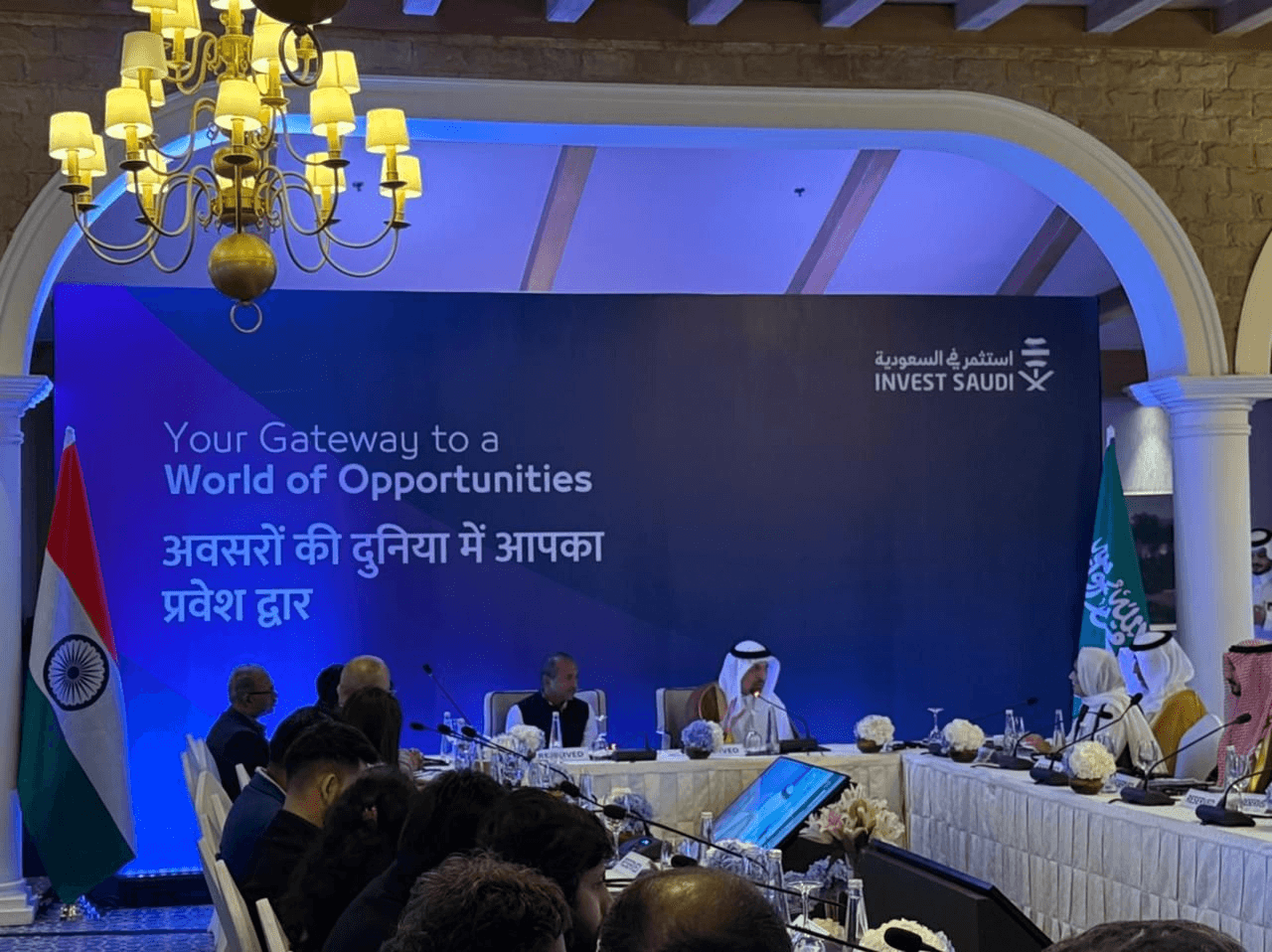 Delegates at the India–Saudi roundtable with Invest Saudi branding and Indian and Saudi flags