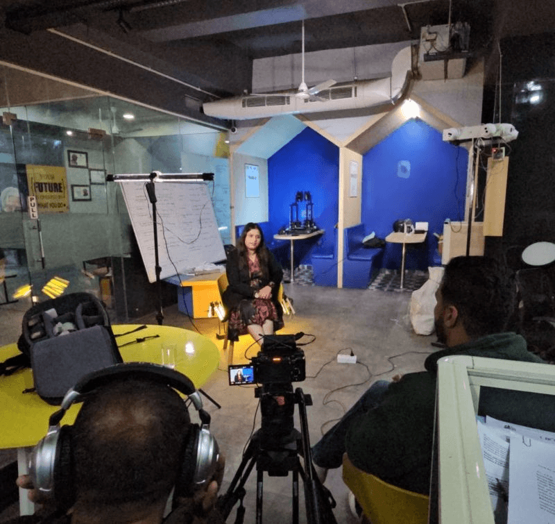 Behind-the-scenes interview filming with cameras and production equipment
